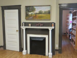 A room with a fireplace and a painting